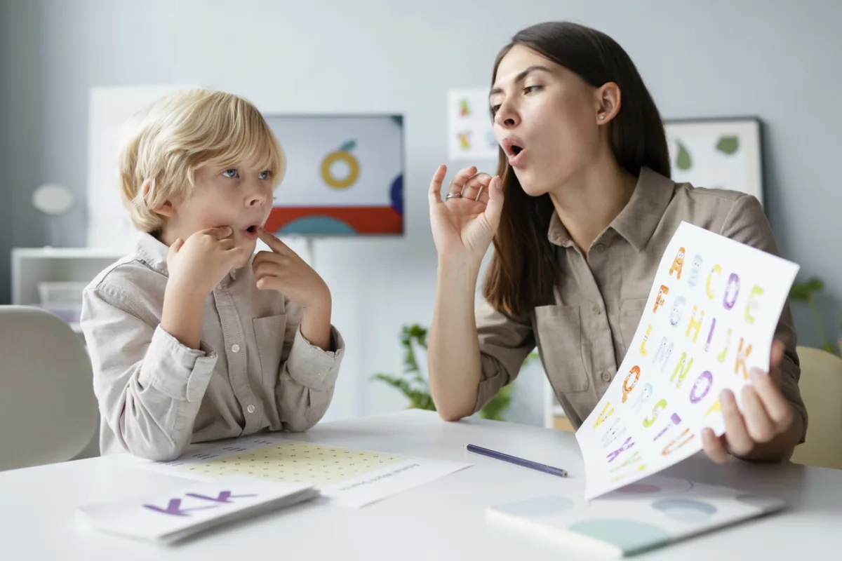 woman-doing-speech-therapy-with-little-blonde-boy-scaled-1-1200x800.webp